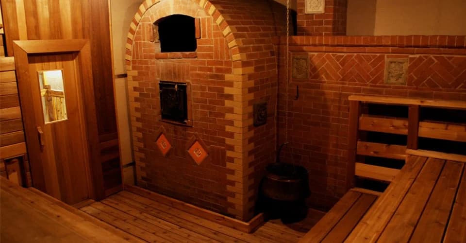 Traditional Russian banya brick oven with cedar wood benches and warm ambient lighting